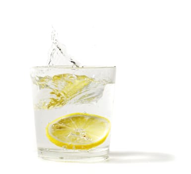 lemon splashing in glass on a white background