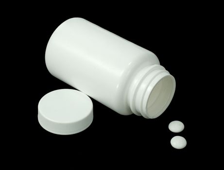 two white pills with white jar on a black background