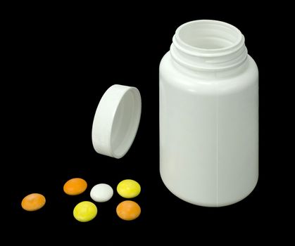 six pills of a different colors with white jar on a black background