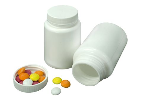 some pills of a different colors with two white jar on a white background