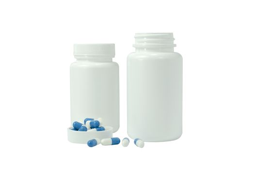 some pills of a white and blue colors with two white jar on a white background
