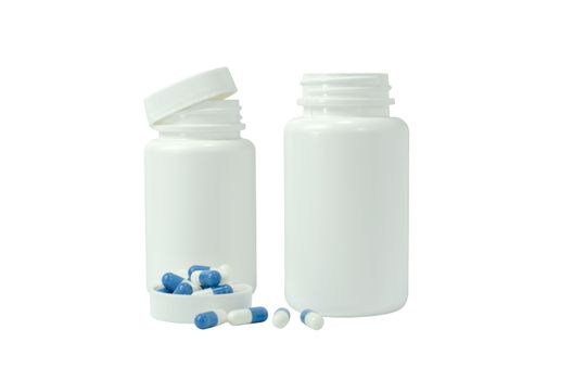 some pills of a white and blue colors with two white jar on a white background