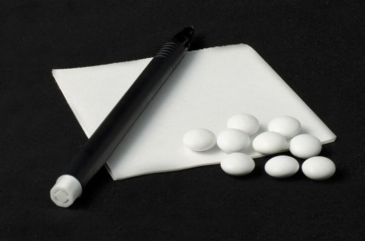 prescription, pills and pen on a dark background