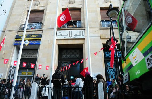 TUNISIA, Tunis: Tunisians shout slogans outside the headquarters of Tunis Governorate, on Habib Bourguiba, during an anti-government demonstration on January 20, 2016  in solidarity with demonstrators demanding jobs in the central Tunisian city of Kasserine Authorities imposed a curfew on the impoverished city of Kasserine, where tensions have been high since January 16, 2016 when a young unemployed man suffered a fatal electric shock during a protest
