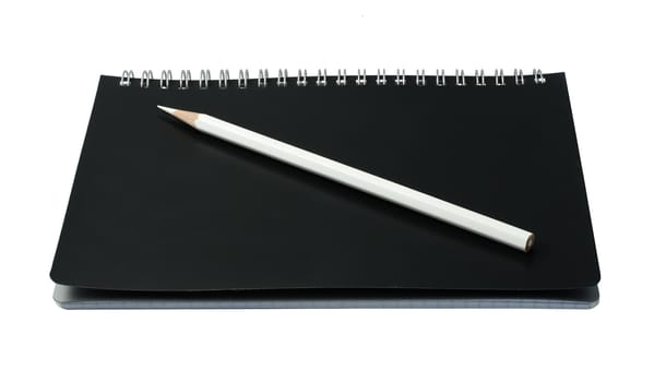 open notebook with pencil on white background