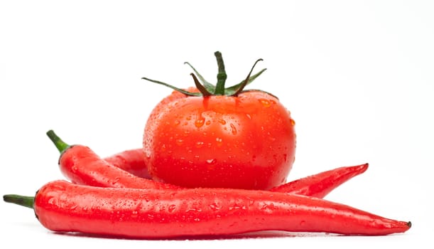 tomatoes and hot peppers on a white background