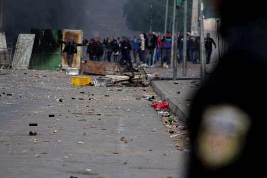 TUNISIA, Kasserine: Tunisian youth face riot policemen during clashes following a protest to demand jobs in the central city of Kasserine, on January 20, 2016. Authorities imposed a curfew on the impoverished city, where tensions have been high since January 16, 2016 when a young unemployed man suffered a fatal electric shock during a protest.