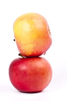 Two red apples on a light background