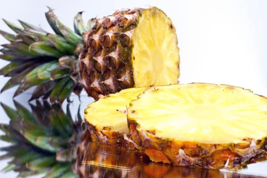 ripe pineapple sliced ​​on a light background