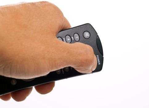 hand holds the TV remote