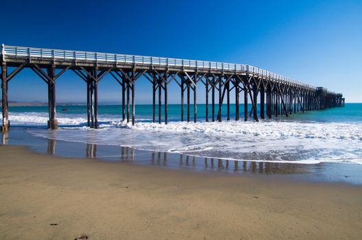 Long pier stands in the Pacific Ocean at California