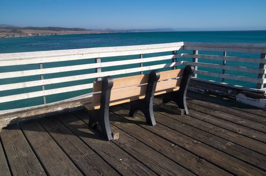 Bench on the pier of California coast