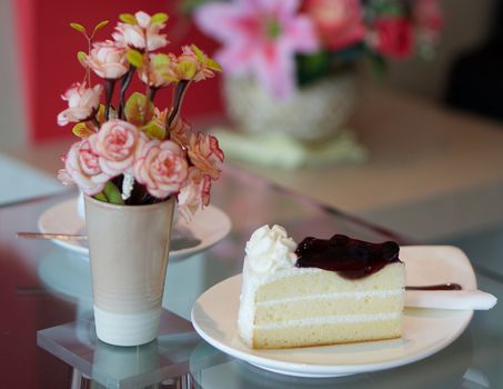 Blueberry cake with cup of coffee on table at restaurant.