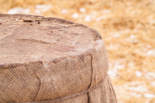 wooden barrel near the straw on the snow