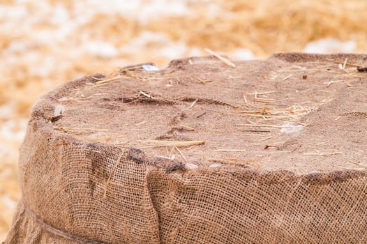 wooden barrel near the straw on the snow