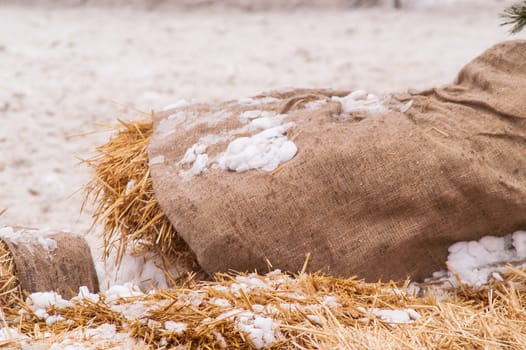 wooden barrel near the straw on the snow