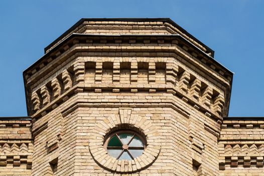 round window in a brick building on a sunny day