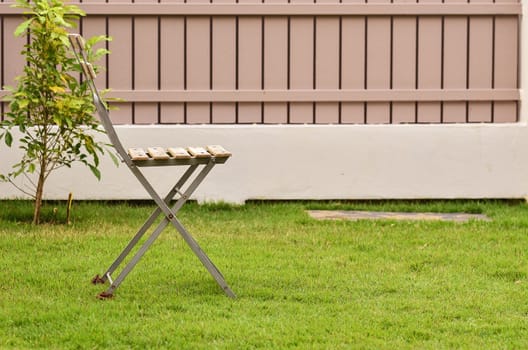 Old chair on green grass