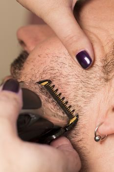 Close-up of mature man at the hairesser for cutting beard