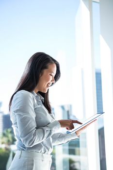 Smiling businesswoman using tablet outdoors