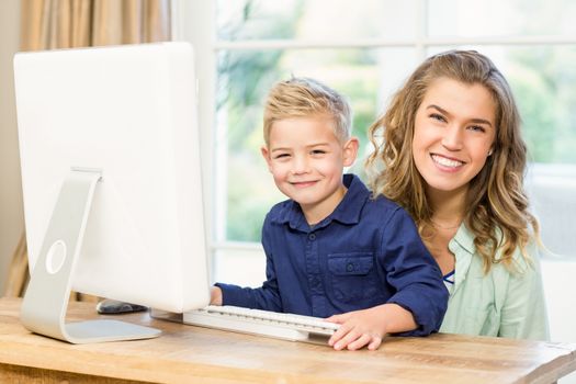 Mother and son using the computer at home