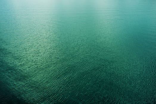 Calm Clear Water Surface Photo Background. Green Lake Waters.