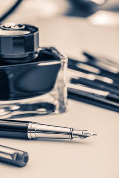 Fountain Pen Handwriting Concept Photo. Fountain Pens and Ink Bottle.