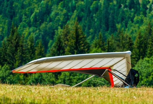 Hang Gliding Air Sport. Non-Motorized Foot-Launch Aircraft. Hang Glider on a Meadow
