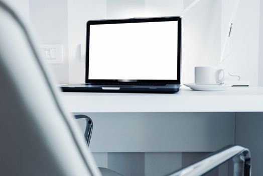 Modern Office Workstation with Laptop Computer. White Furnished Office Space.