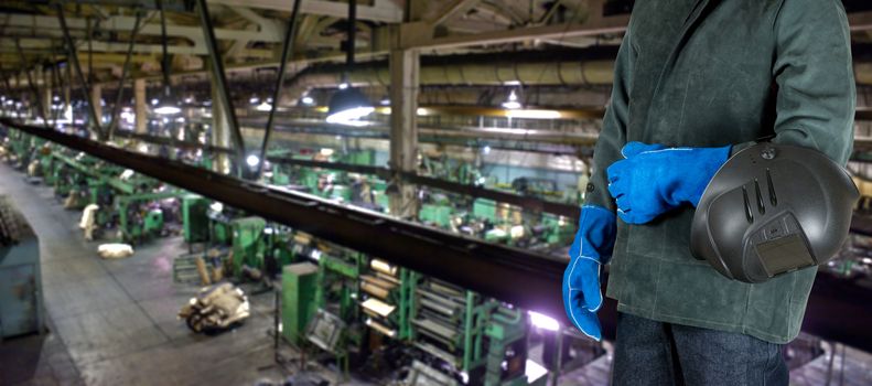 Worker welder with instruments at industrial factory