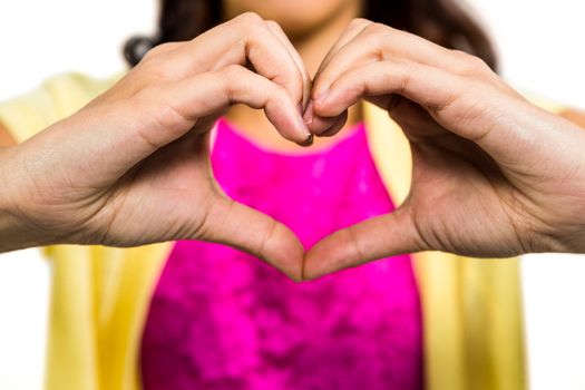 Woman with heart shape made from fingers