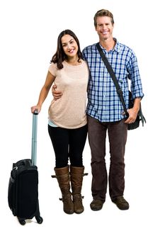 Portrairt of cheerful couple with luggage standing against white background