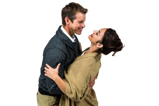 Happy romantic couple hugging against white background