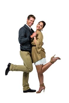 Portrait of happy romantic couple dancing against white background