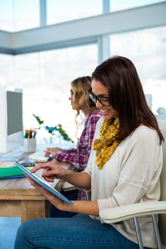 Two girls work at office on computer and tablet