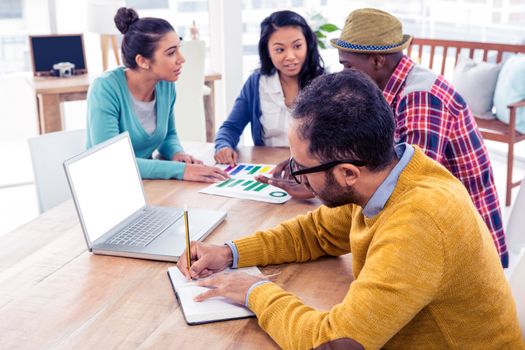 Business people working while sitting in creative office