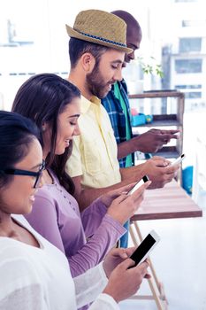 High angle view of business colleagues using phone in creative office