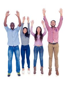 Full length portrait of happy multi-ethnic friends jumping with arms raised against white background