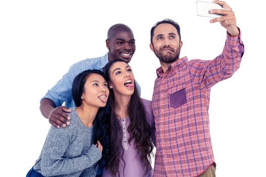 Happy multi-ethnic friends making face while taking selfie against white background