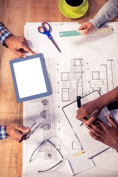 Cropped image of business people discussing plan at desk