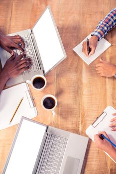 Cropped image of business people working at desk in office