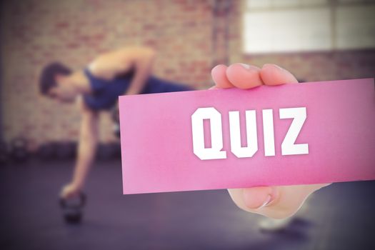 The word quiz and young woman holding blank card against 