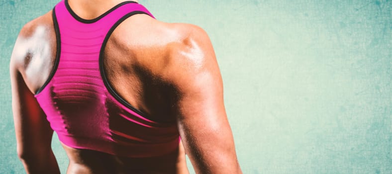 Close up of muscular woman against blue background