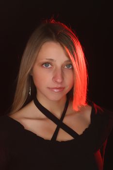 Portait of a beautiful girl made with ring light and some red backlight