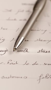 Close-up desk diary, schedule book, stress note, with a pen