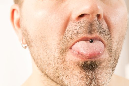 close-up of a mature man showing off his tongue ring