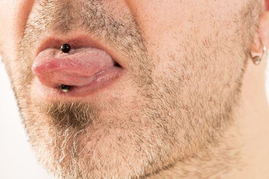 close-up of a mature man showing off his tongue ring