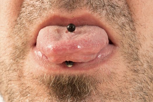 close-up of a mature man showing off his tongue ring