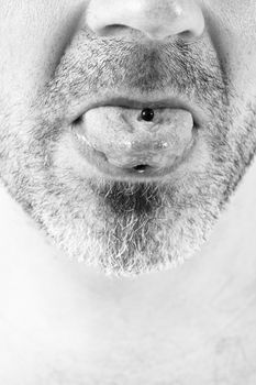 close-up of a mature man showing off his tongue ring