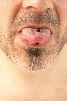 close-up of a mature man showing off his tongue ring